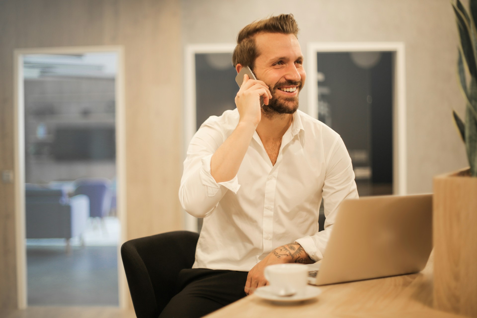 A real estate agent on the phone, smiling.